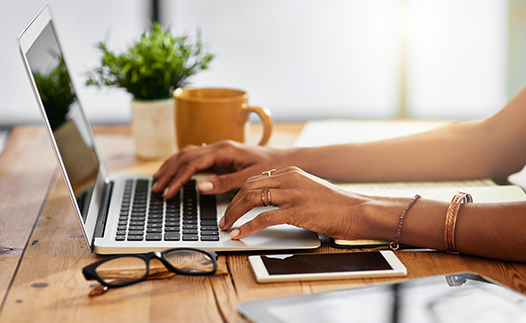 Person typing on laptop at table