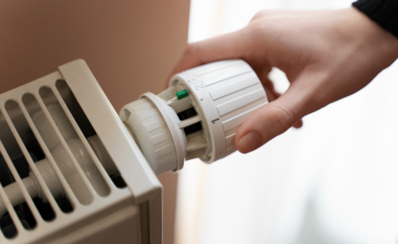 Close Up Hand Turning Up Heater