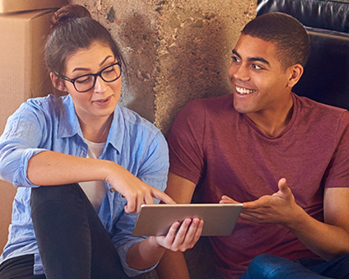 Couple in new house surrounded with boxes - Equity Loan page