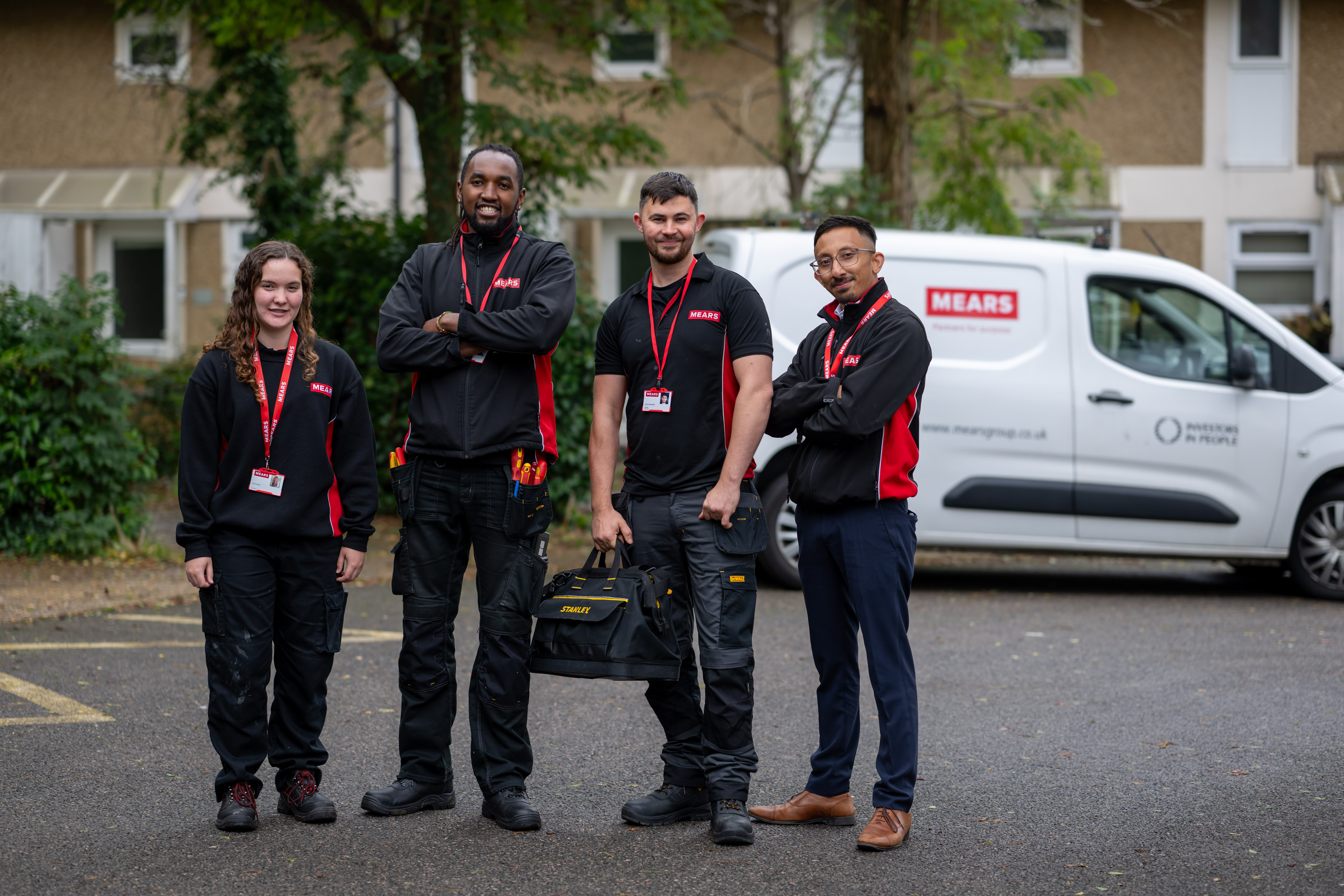Four Mears operatives with van behind