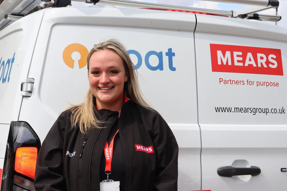 Image shows Katie from Mears standing on front of van