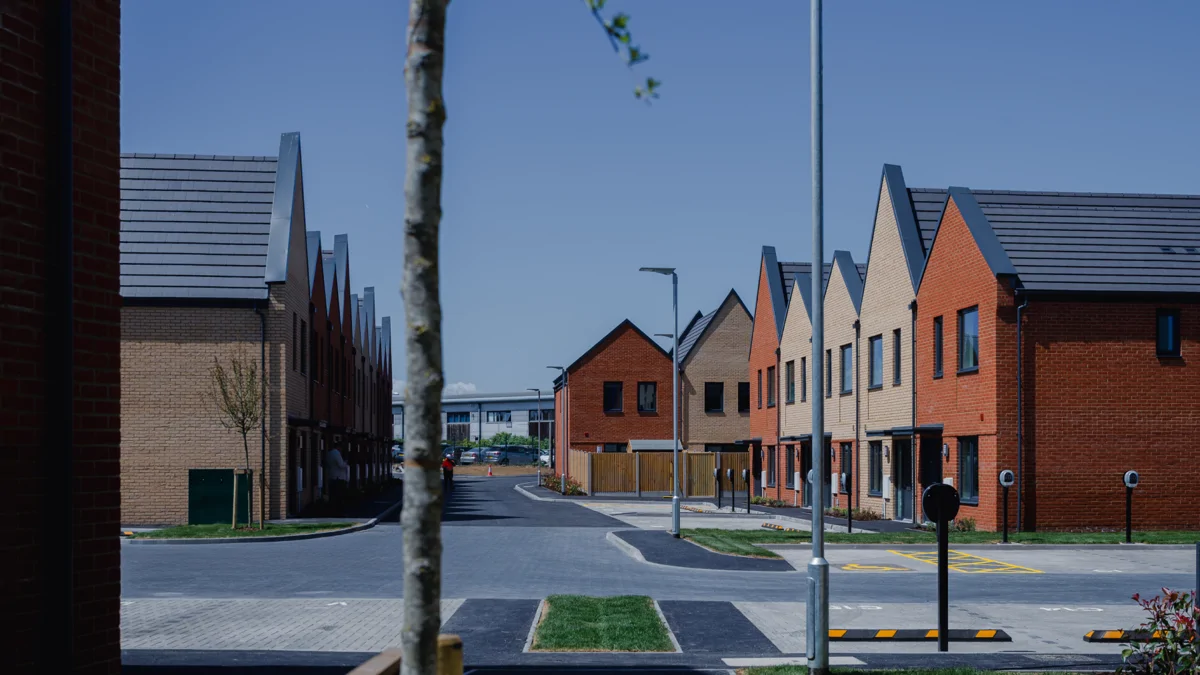 Image shows a street of new housing on a sunny day