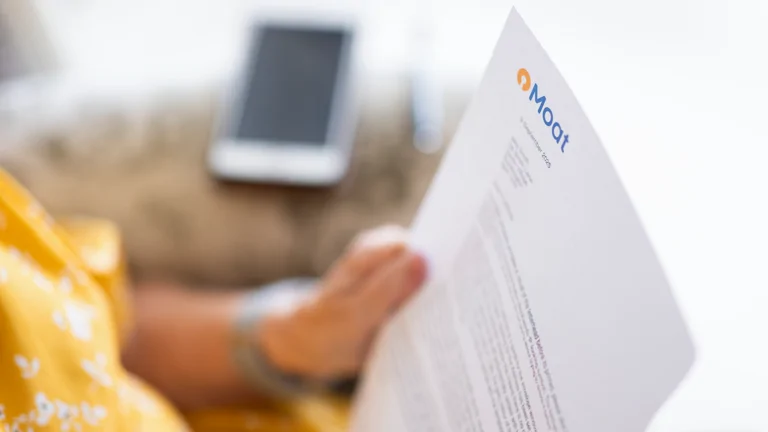 Image shows a woman reading a letter from Moat