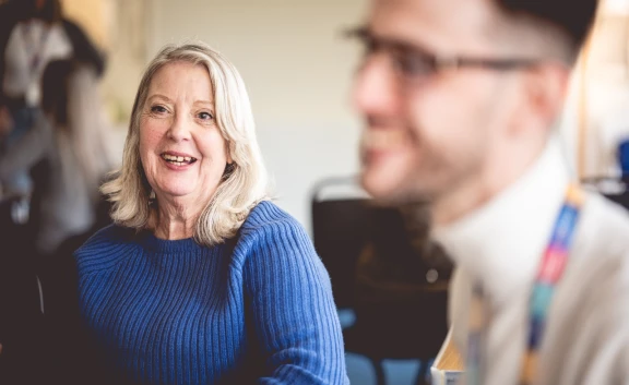 Colleague and customer smiling at Meet Moat event