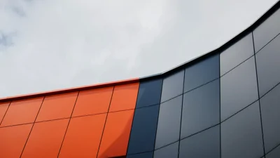 Metal external building cladding in orange and grey