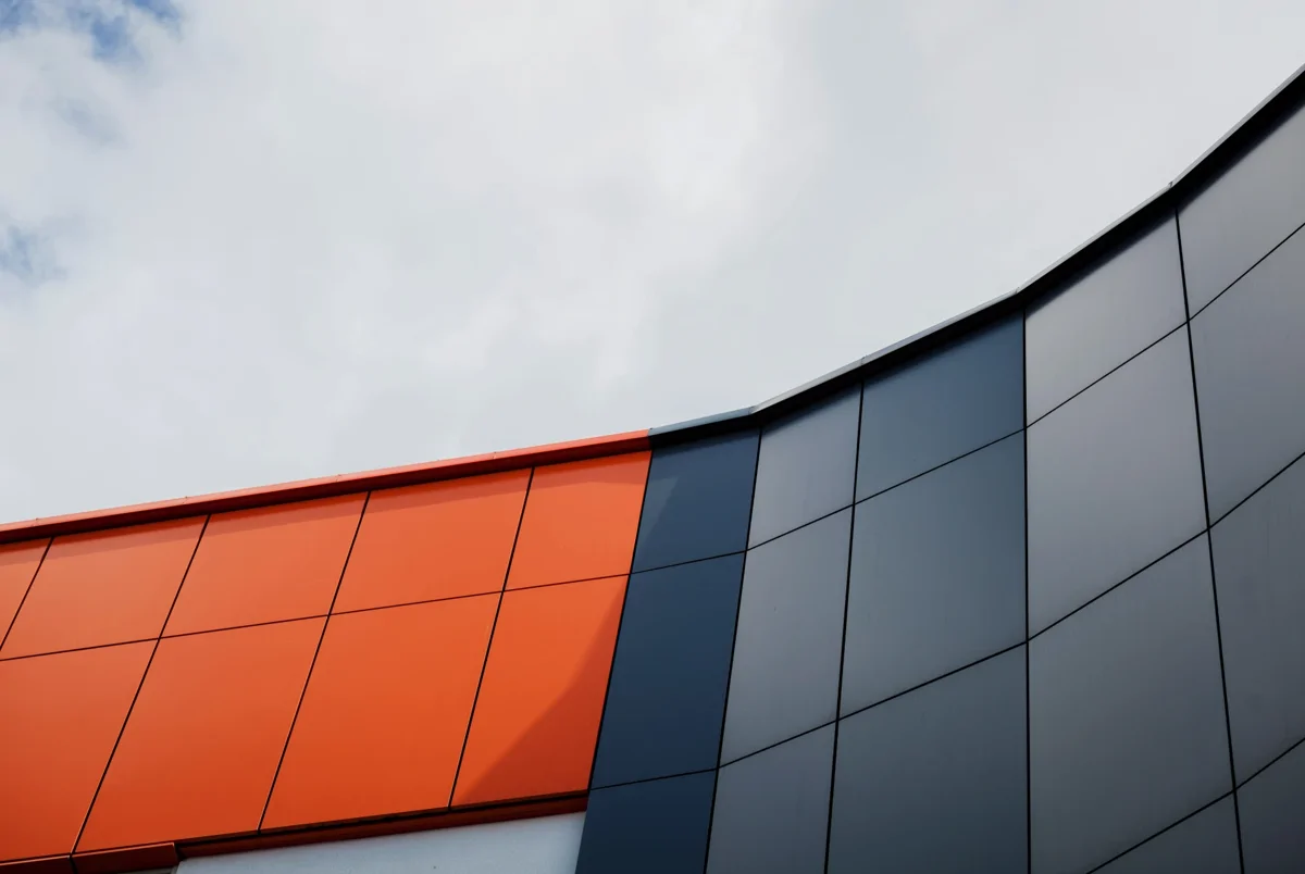 Metal external building cladding in orange and grey