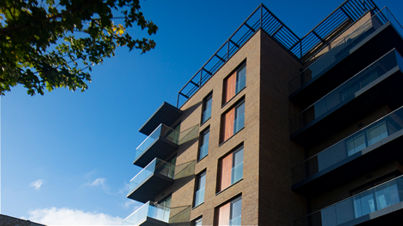 Looking up at high rise flats with balconies